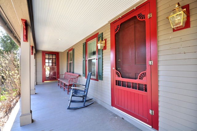 view of exterior entry with a porch