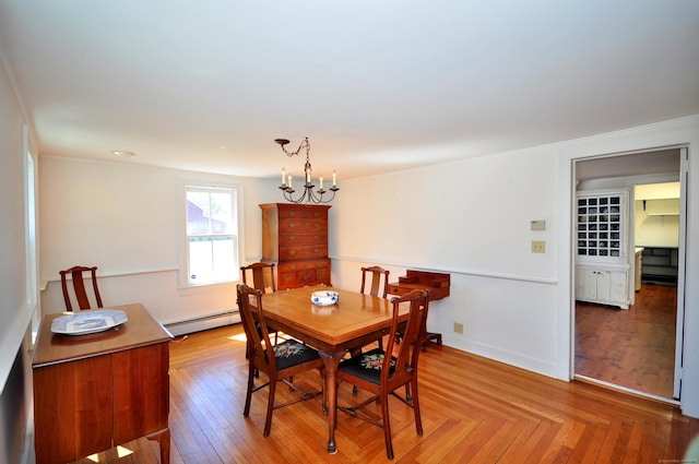 dining room featuring a chandelier and baseboard heating