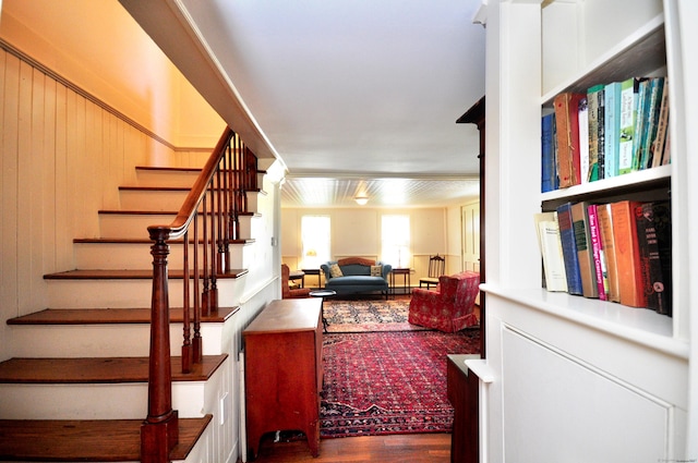stairway featuring wooden walls and wood finished floors