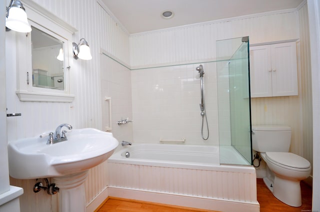 bathroom featuring wood finished floors, toilet, and shower / tub combination