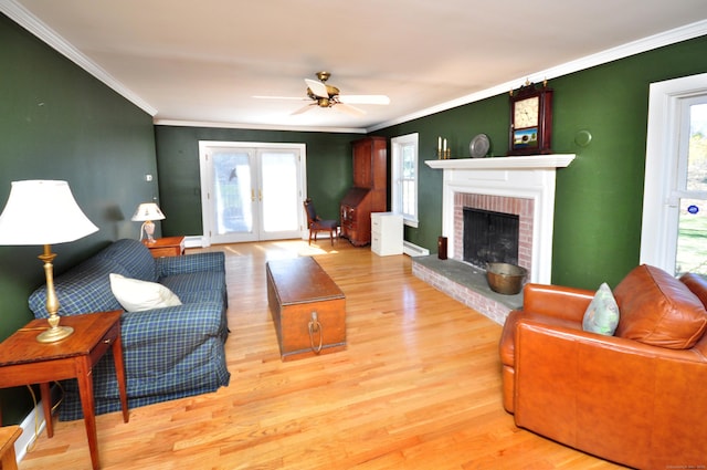 living room featuring ornamental molding, a ceiling fan, and wood finished floors