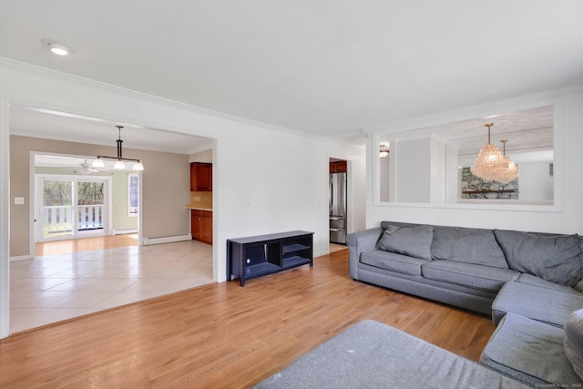 living room with crown molding, baseboards, a baseboard radiator, and light wood-style flooring