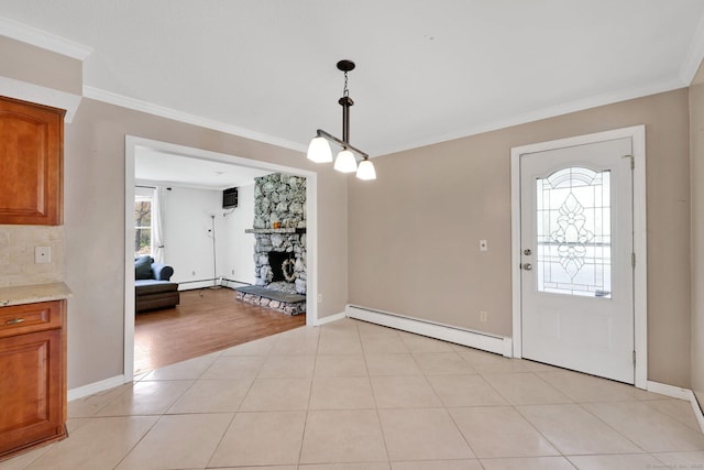 foyer entrance with baseboards, ornamental molding, a fireplace, and a baseboard heating unit