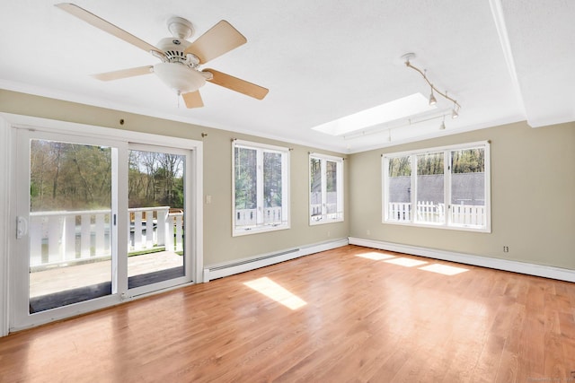 unfurnished sunroom with a skylight, rail lighting, and a wealth of natural light