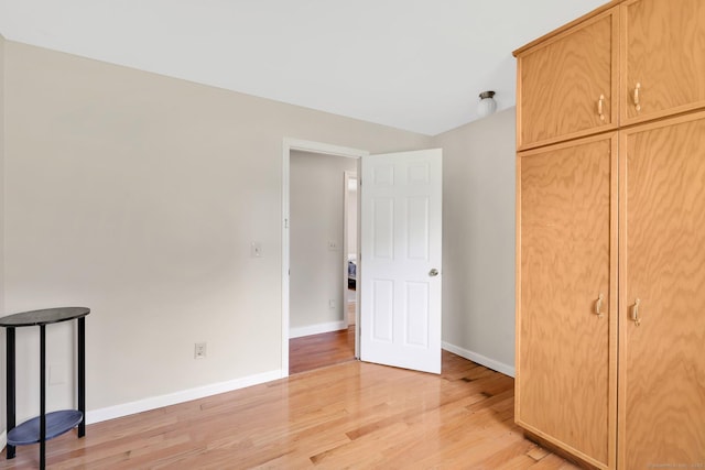 unfurnished bedroom featuring baseboards and light wood finished floors