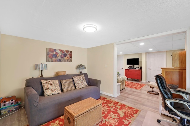 interior space featuring recessed lighting, baseboards, and light wood finished floors