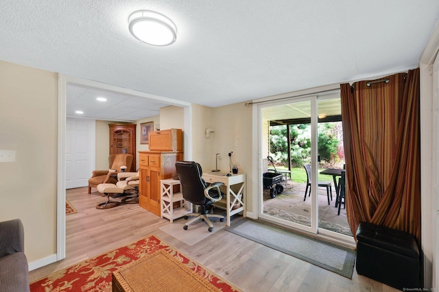 office featuring baseboards, recessed lighting, and light wood-style flooring