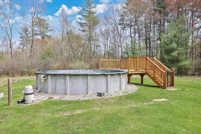 view of yard featuring a wooden deck, stairs, and a covered pool