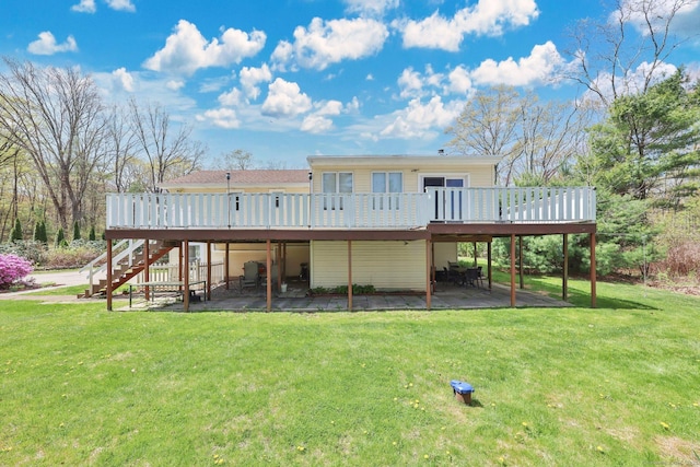 rear view of house with stairway, a deck, and a patio area