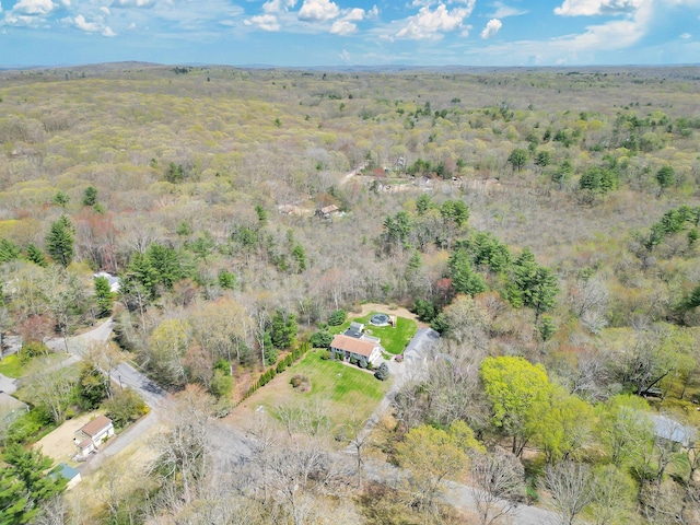 drone / aerial view with a wooded view