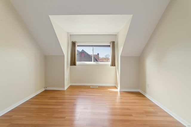 72 Montoya Dr Unit 72, Branford, CT 06405 - bonus room with baseboards, vaulted ceiling, and light wood-style flooring