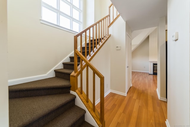 72 Montoya Dr Unit 72, Branford, CT 06405 - stairway with a glass covered fireplace, wood finished floors, and baseboards
