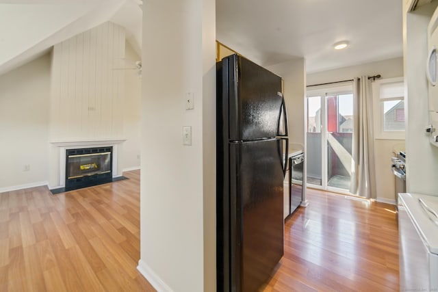 72 Montoya Dr Unit 72, Branford, CT 06405 - kitchen with a fireplace with flush hearth, baseboards, light wood finished floors, and freestanding refrigerator