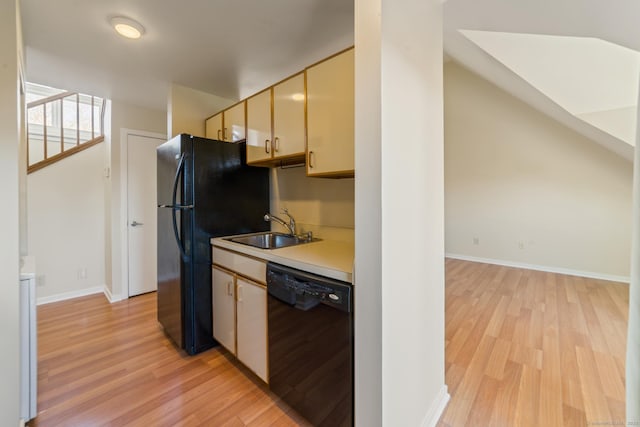 72 Montoya Dr Unit 72, Branford, CT 06405 - kitchen featuring a sink, black appliances, cream cabinets, light wood finished floors, and light countertops