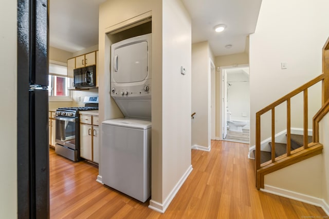 72 Montoya Dr Unit 72, Branford, CT 06405 - washroom with baseboards, stacked washer / drying machine, light wood-style floors, and laundry area