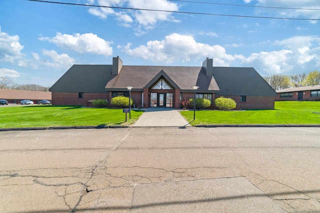 72 Montoya Dr Unit 72, Branford, CT 06405 - english style home featuring brick siding, french doors, a chimney, and a front yard