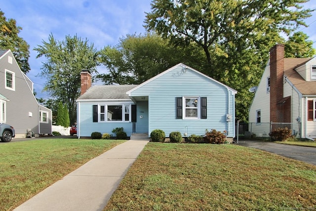 136 Edgemere Ave, West Hartford, CT 06110 - view of front of home featuring a chimney, fence, and a front yard