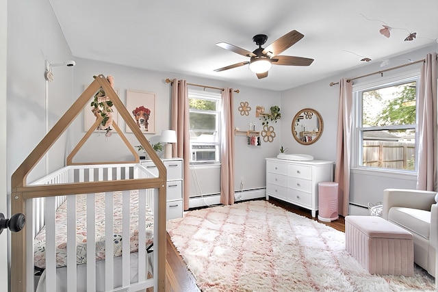 136 Edgemere Ave, West Hartford, CT 06110 - bedroom featuring a crib, multiple windows, and a baseboard radiator