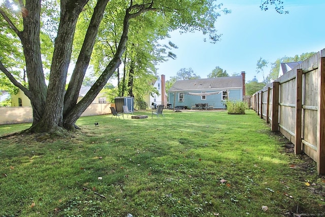 136 Edgemere Ave, West Hartford, CT 06110 - view of yard featuring an outdoor fire pit and a fenced backyard