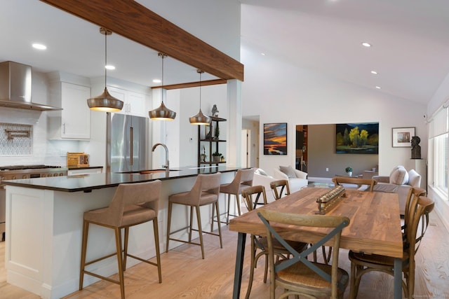 dining space featuring light wood-style flooring, recessed lighting, and lofted ceiling