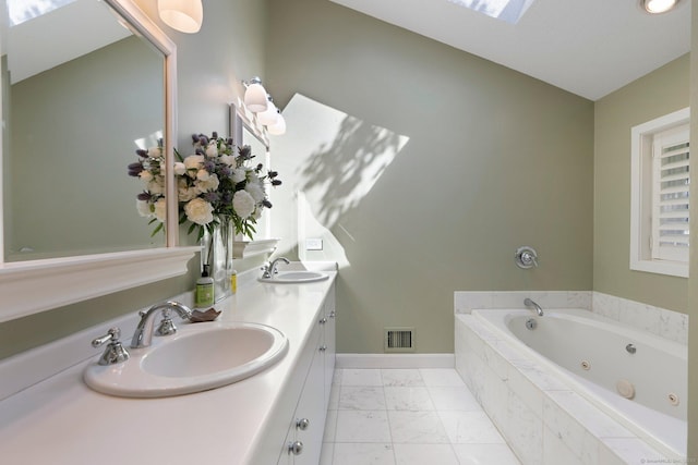bathroom with marble look tiles, a jetted tub, baseboards, and double vanity