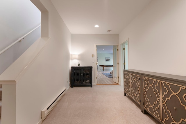 corridor with a baseboard heating unit, light colored carpet, recessed lighting, and a baseboard radiator