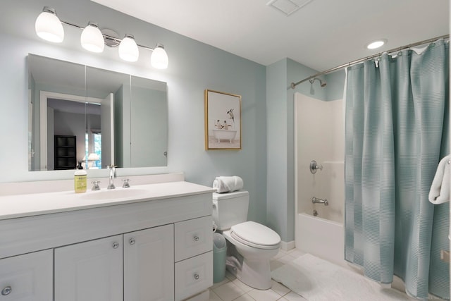 bathroom with tile patterned floors, shower / bath combo with shower curtain, vanity, and toilet