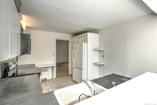 472 Westover Rd, Stamford, CT 06902 - kitchen featuring stainless steel electric range, dark countertops, a sink, and freestanding refrigerator
