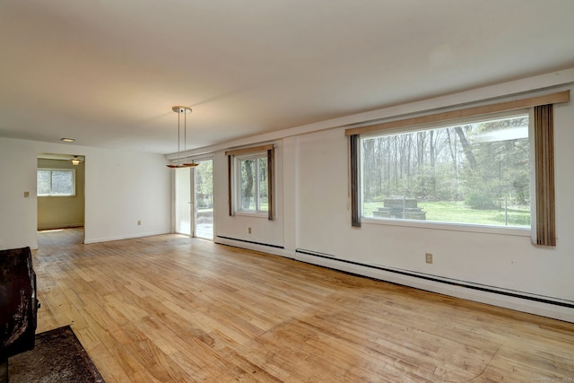 472 Westover Rd, Stamford, CT 06902 - unfurnished living room with a baseboard heating unit and light wood-type flooring