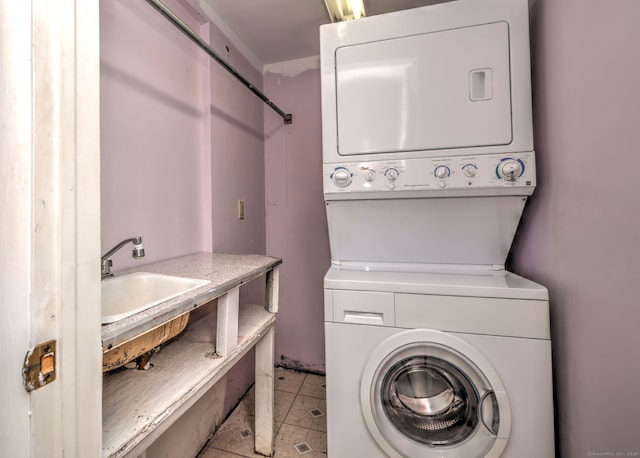472 Westover Rd, Stamford, CT 06902 - laundry area with light tile patterned floors, laundry area, stacked washer / dryer, and a sink
