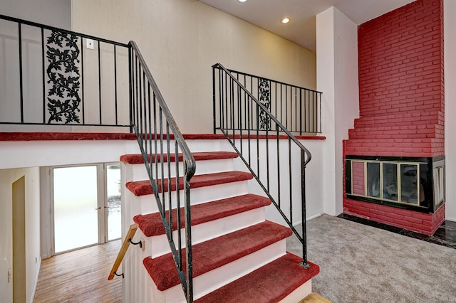 472 Westover Rd, Stamford, CT 06902 - stairs featuring a fireplace, french doors, and recessed lighting