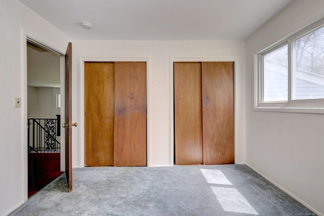 472 Westover Rd, Stamford, CT 06902 - unfurnished bedroom featuring multiple closets and carpet