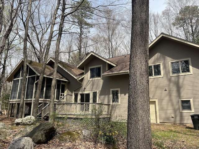 9 Stonehedge Way, Granby, CT 06060 - rear view of house featuring a deck, a shingled roof, and a sunroom