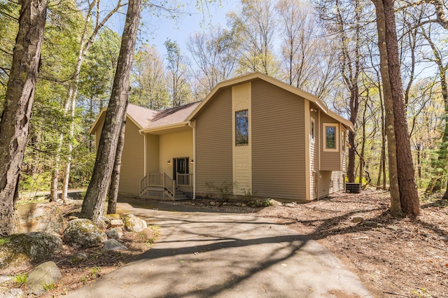 9 Stonehedge Way, Granby, CT 06060 - view of property exterior with roof with shingles and aphalt driveway