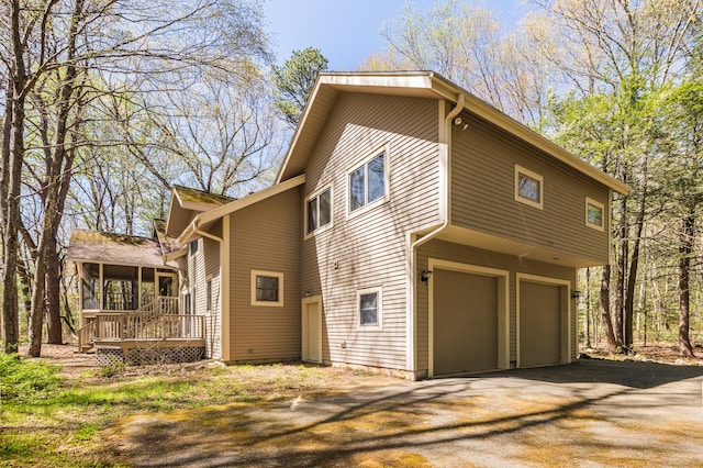 9 Stonehedge Way, Granby, CT 06060 - view of home's exterior with an attached garage, aphalt driveway, and a deck