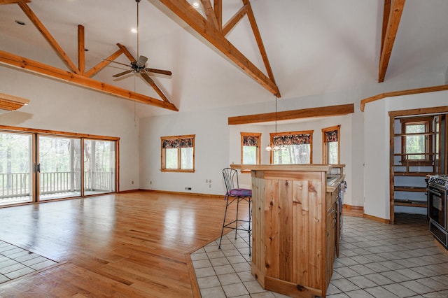9 Stonehedge Way, Granby, CT 06060 - kitchen featuring beamed ceiling, baseboards, a kitchen breakfast bar, high vaulted ceiling, and a ceiling fan
