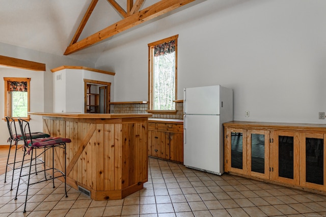 9 Stonehedge Way, Granby, CT 06060 - kitchen with visible vents, freestanding refrigerator, light tile patterned flooring, and a healthy amount of sunlight