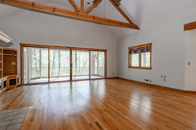 9 Stonehedge Way, Granby, CT 06060 - unfurnished living room with visible vents, beamed ceiling, light wood-style floors, baseboards, and high vaulted ceiling