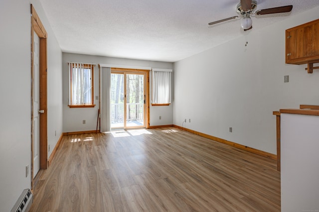9 Stonehedge Way, Granby, CT 06060 - unfurnished room featuring ceiling fan, a textured ceiling, baseboard heating, baseboards, and light wood finished floors