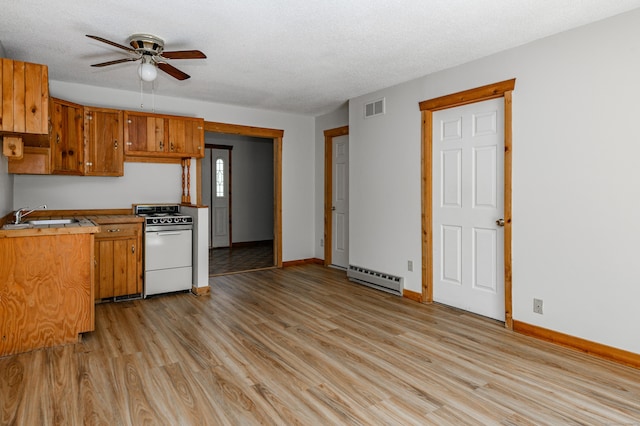 9 Stonehedge Way, Granby, CT 06060 - kitchen with ceiling fan, visible vents, baseboard heating, stove, and light wood-style floors