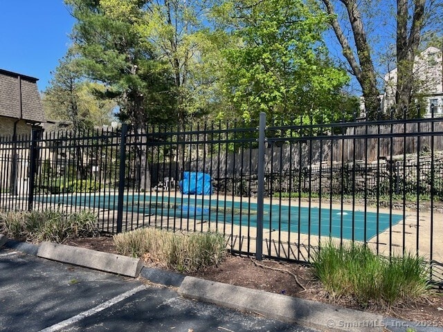 view of swimming pool with fence and a pool