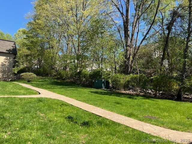 view of property's community with a lawn