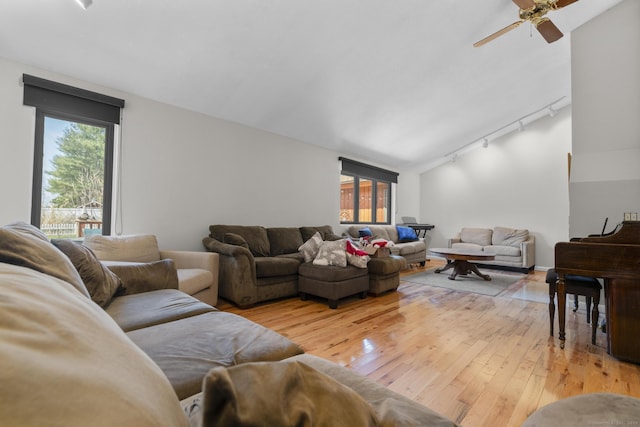 living room with track lighting, a ceiling fan, and light wood-style flooring