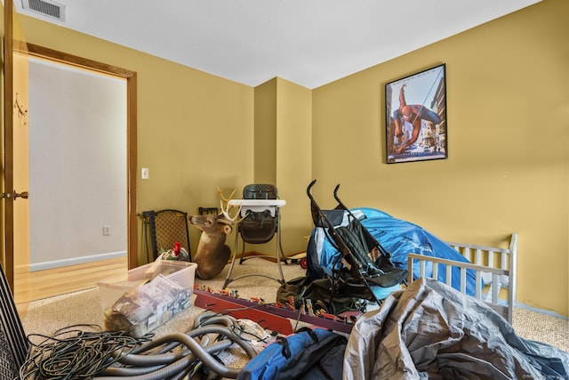 bedroom with visible vents and wood finished floors