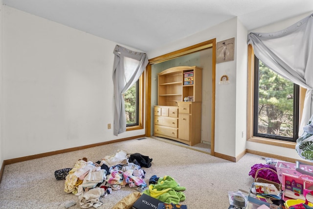 unfurnished bedroom with baseboards and carpet flooring
