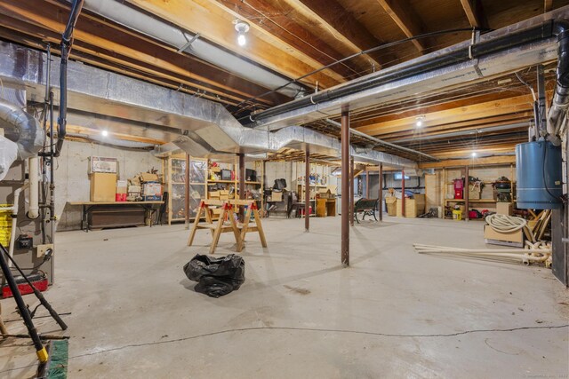 unfinished basement featuring gas water heater