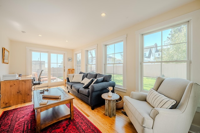 living area featuring plenty of natural light, recessed lighting, and light wood-style floors