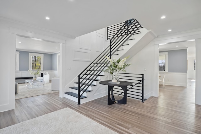 433 Belden Hill Rd, Wilton, CT 06897 - staircase with crown molding, a decorative wall, wood finished floors, a wainscoted wall, and recessed lighting