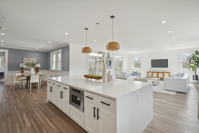 433 Belden Hill Rd, Wilton, CT 06897 - kitchen featuring open floor plan, a decorative wall, white cabinets, wainscoting, and wood finished floors