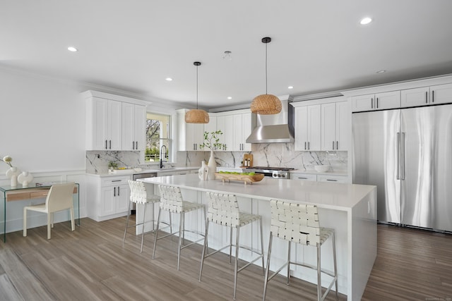 433 Belden Hill Rd, Wilton, CT 06897 - kitchen featuring stainless steel refrigerator, wall chimney exhaust hood, range, a center island, and wood finished floors